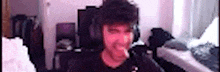 a pixelated image of a man wearing headphones and a black shirt