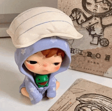 a doll with a pillow on her head is sitting next to a book titled echo