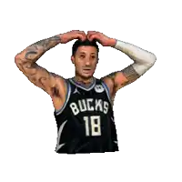 a man in a bucks jersey making a heart shape with his hands