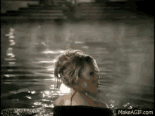 a woman is taking a bath in a pool .