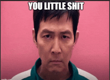 a man in a green shirt with the words you little shit written on it