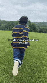 a person in a striped shirt is walking through a grassy field with the caption i wrote this song about you ( threat )