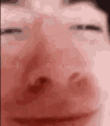 a close up of a person 's face with their eyes closed and their mouth open .