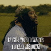 a man with dreadlocks and a bandana on his head sings if this world wants to take me down