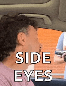 a man sitting in a car with the words side eyes written above him