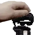 a pixelated image of a hand holding a key