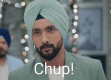 a man in a turban with the word chup written on his face