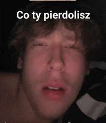 a close up of a man 's face with the words " co ty pierdolisz " on the bottom