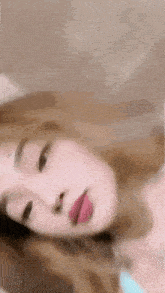 a close up of a woman laying on her back with her tongue out .