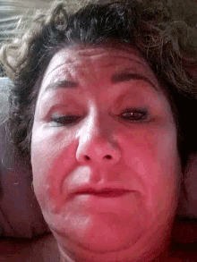 a close up of a woman 's face with red skin