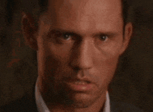 a close up of a man 's face with a blurred background .