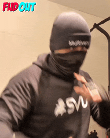 a man wearing a mask and a sweatshirt that says svu