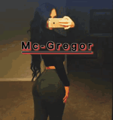 a woman taking a picture of herself with the name mc-gregor
