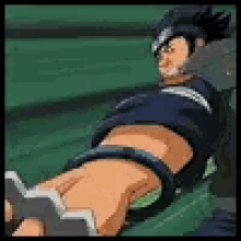a man in a blue shirt is laying on a green surface with his legs crossed .
