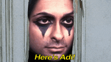 a woman looking through a hole in a wall with the words here 's adi