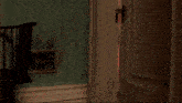 a child in a red jumpsuit is standing in a doorway with a tac juntos logo behind him