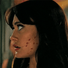 a close up of a woman 's face with a few spots on her face