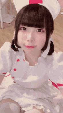 a girl in a nurse costume is looking at the camera and smiling