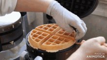 a person is making a waffle in a waffle maker made in animotica