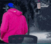 a person in a pink hoodie is standing in front of a sign that says shack