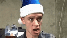 a man wearing a santa hat and making a funny face