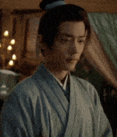 a man in a kimono is standing in front of a bed