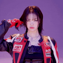 a woman wearing a red and black jacket that says moto duhan