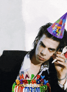 a man wearing a party hat with the words happy birthday on it
