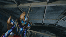 a purple and gold superhero with a red belt is standing in a dark room