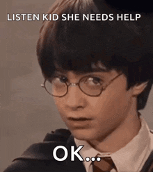 harry potter is wearing glasses and a suit and tie and making a funny face .