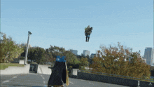 a person is flying through the air with a sign in the background that says ' a ' on it