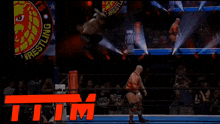 two men are wrestling in a ring with a sign that says wrestling behind them