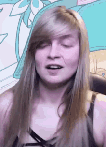 a woman with long blonde hair is making a funny face