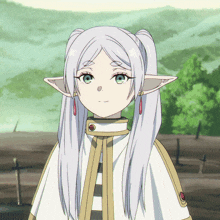 a girl with long white hair and elf ears is wearing a striped cape