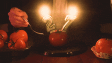 a person is lighting a candle with the number 2 on it