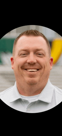 a man in a white shirt is smiling with his eyes closed .