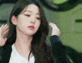 a close up of a woman adjusting her hair with her hands