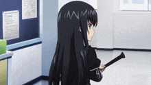 a girl with long black hair is holding a stick in front of a blackboard