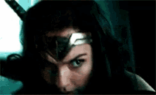 a close up of a woman wearing a wonder woman costume and a helmet .