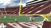 a football game is being played in a stadium and the player number 18 is running towards the goal line
