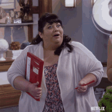 a woman holding a red folder and a pencil with netflix written on the bottom right