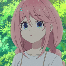 a girl with pink hair and blue eyes is looking at the camera