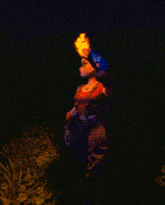 a woman with blue hair is holding a torch in her hand