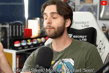 a man is talking into a microphone while wearing a shirt that says secret lab
