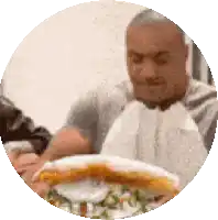 a blurry picture of a man eating a hamburger in a circle