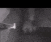 a black and white photo of a person 's hand on a table