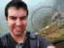 a blurry picture of a man 's face with a yellow object in the background