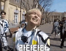 a man is making a funny face while standing on a sidewalk in front of a building .