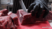 a person is cutting a piece of meat on a cutting board that says made in animatica on the bottom