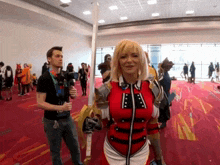 a man stands next to a woman in a costume